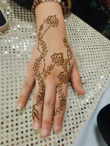 Small flowering vines and delicate leaf motifs on a hand and wrist